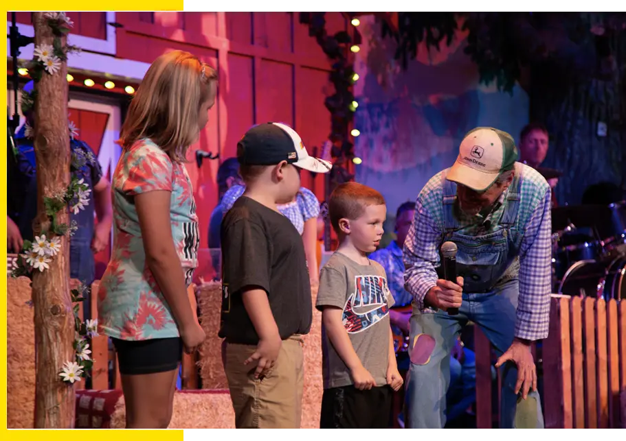 three kids on stage at The Comedy Barn