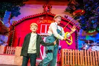Kid performing a trick with a Comedy Barn performer